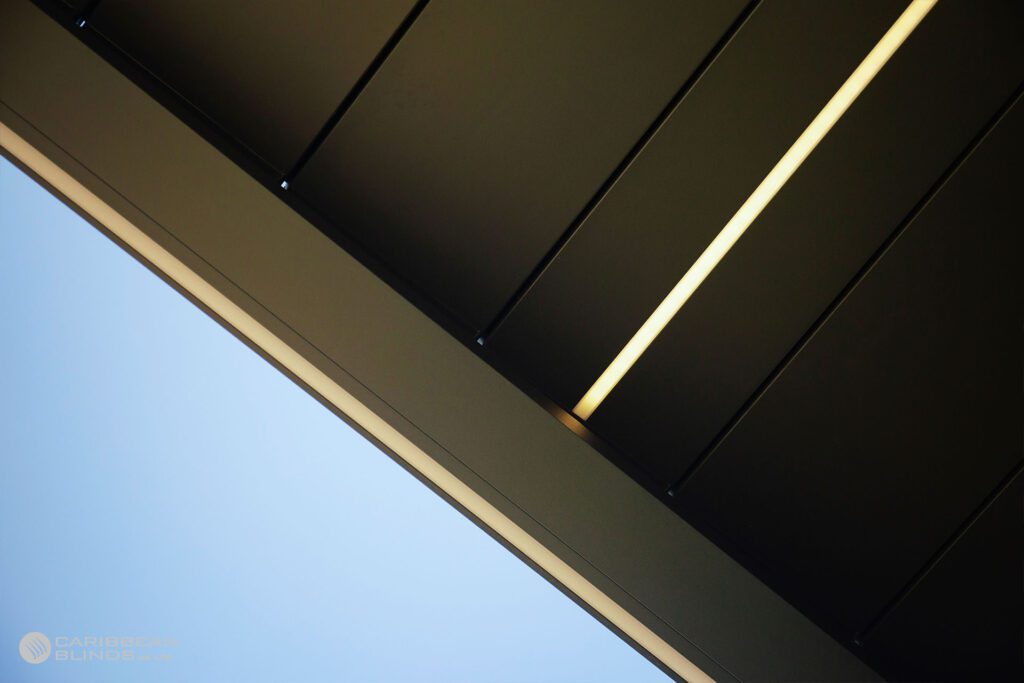 An LED light stripped embedded into the roof of a louvered pergola